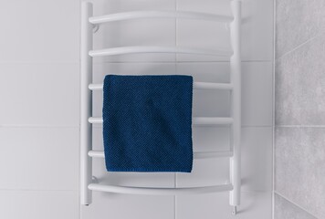 A Stylish White Towel Rack with a Blue Towel Hanging in a Modern Bathroom Setting, Showcasing Elegance and Functionality in Home Decor
