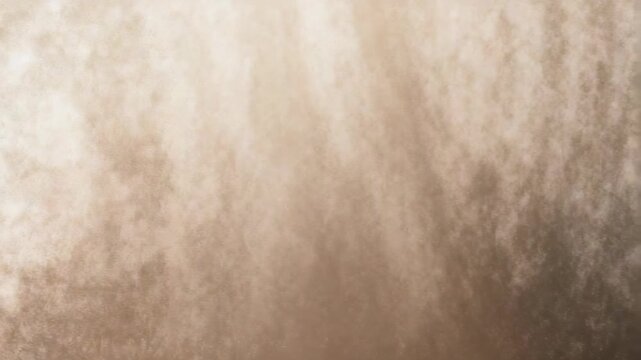 This abstract beige and brown texture features a gentle gradient and cloudy pattern, ideal for digital art or web backgrounds. The soft grunge effect adds depth and visual interest