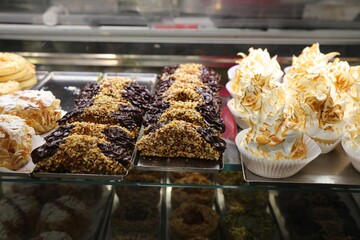 Sweets of Catania, Sicily. Italian pastries: cannoli with chocolate cream and lemon meringue cupcakes.