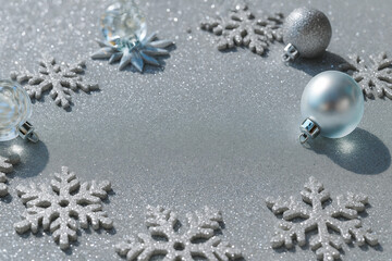 Silver Winter Background with Glitter Snowflakes and Frosted Christmas Ornaments