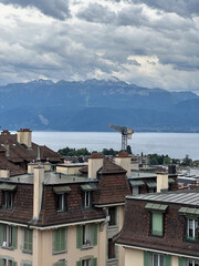 Overcast View of a European City by a Lake with Distant Mountains