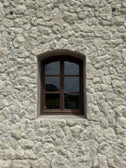 Rustic Stone Wall with Arched Wooden Window