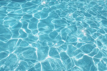 Fototapeta premium Crystal clear swimming pool water surface with sunlight caustics