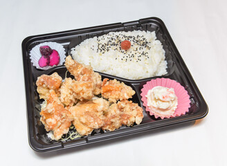 Delicious Japanese Karaage Bento Box lunch with crispy fried chicken and seasoned rice ready for takeout