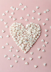 Obraz premium Pastel Pink Minimalist Valentine's Day Confetti Heart with Chocolate – Vertical Clean Background
