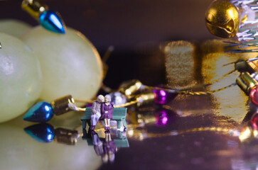 Eternal love on new year's eve, miniature elderly couple waiting for the grapes miniature senior couple sharing intimate moment on bench