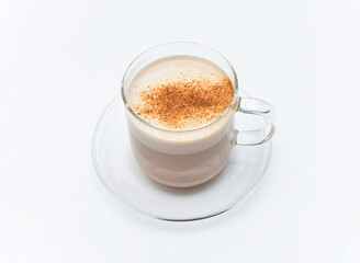 Delicious cappuccino in transparent glass cup on saucer