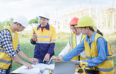 Male and female engineers who are Asian professionals in the construction industry focus on village design and architecture to create sustainable houses for people to rent and sell.