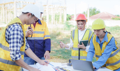 Male and female engineers who are Asian professionals in the construction industry focus on village design and architecture to create sustainable houses for people to rent and sell.