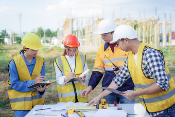 Male and female engineers who are Asian professionals in the construction industry focus on village design and architecture to create sustainable houses for people to rent and sell.