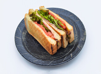 Deliciously toasted club sandwich stacked high with fresh lettuce and tomato ready for a perfect lunch break