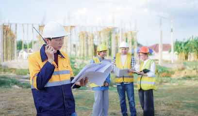 Male and female engineers who are Asian professionals in the construction industry focus on village design and architecture to create sustainable houses for people to rent and sell.