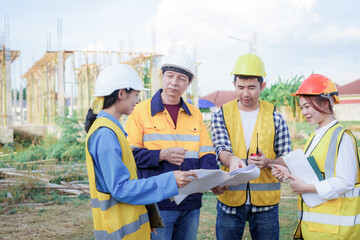 Male and female engineers who are Asian professionals in the construction industry focus on village design and architecture to create sustainable houses for people to rent and sell.