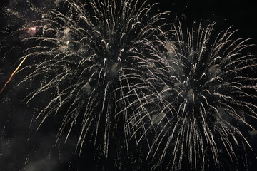Obraz premium Spectacular Golden Fireworks Exploding in the Night Sky with Digital Noise and Grain Texture for Celebration Background