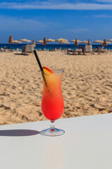 Sex on the beach cocktail on beautiful sunny sand beach background