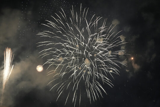 Spectacular Golden Fireworks Exploding in the Night Sky with Digital Noise and Grain Texture for Celebration Background
