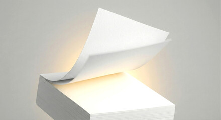 Stack of White Paper with One Sheet Gently Lifting and Illuminated image photo