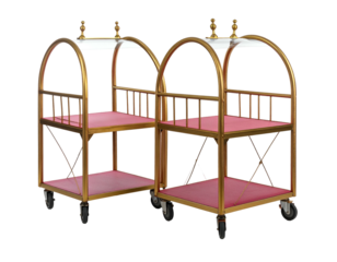 Two antique golden luggage carts with red shelves