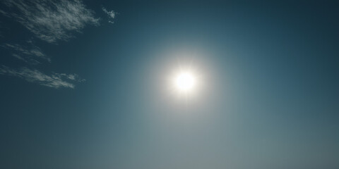 Obraz premium Bright sun shines in blue sky with a few clouds during the afternoon hours over an open landscape