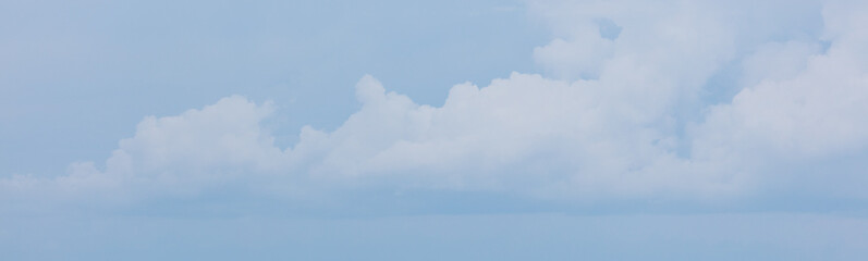 A blue sky with a few clouds