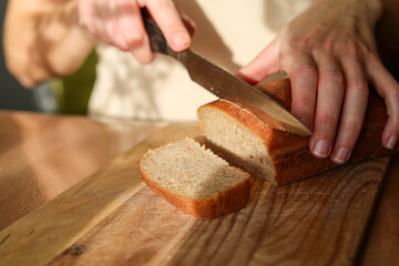 Making dough, baking and slicing rya homemade bread on kitchen