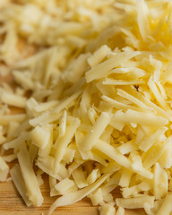 Grated Cheese on Wooden Cutting Board