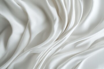 Obraz premium Elegant white flowing silk fabric texture with soft waves.