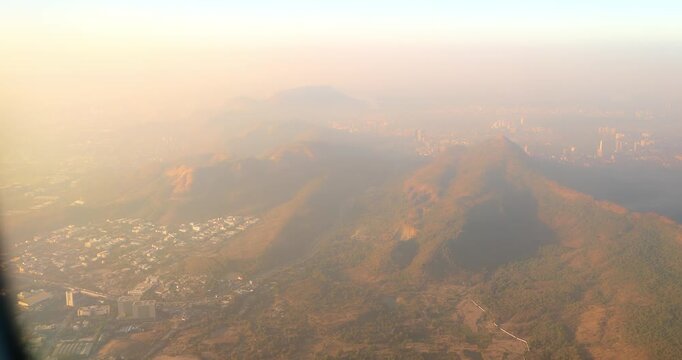 Shil Phata - Mahape Rd, MIDC Industrial Area, Mahape, Navi Mumbai, Maharashtra, India. Mumbai Metropolitan Region. Aerial View From Airplane Window On View of the Mumbai suburb district. Evening