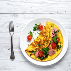 Frittata with ham, veggies, and herbs on a plate