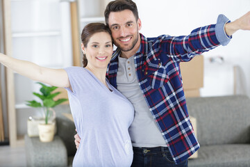 Fototapeta premium happy pregnant woman with her husband at home