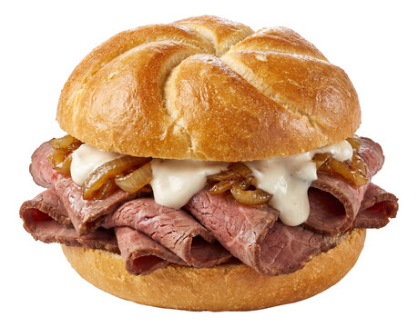 Roast beef sandwich with arranged layers of roast beef, horseradish sauce, and caramelized onions on a kaiser roll.