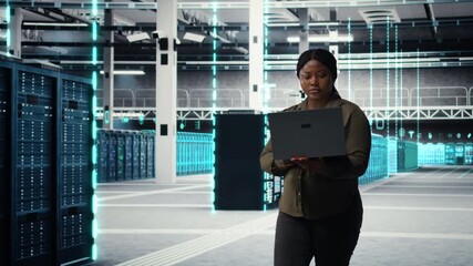IT specialist walks through data center mapping server racks with laptop for virtualization. VFX compositing scanning lines showing concept of software developer creating server hub digital twin - Powered by Adobe