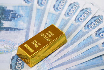 Banknotes of Russian rubles with gold ingot. The financial system of Russia, backed by gold. World monetary system. investment in precious metals against the backdrop of sanctions and crisis