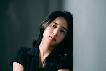 asian woman portrait solid color background