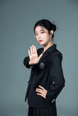 A Korean school woman, on a solid color background,Giving directions with one hand, Blazer uniform
