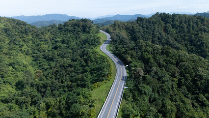 Road number three, Nan Province, aerial view of a beautiful road through the mountains full of green trees. Travel concept, transportation concept.	