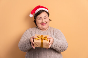 excited caucasian woman giving gift box in studio shot. christmas, gift box concept.