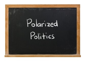Polarized politics handwritten in white chalk on a black chalkboard isolated on white