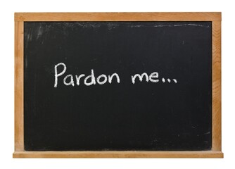 Pardon me handwritten in white chalk on a black chalkboard isolated on white
