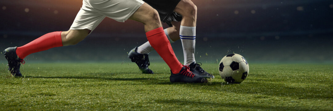 Physical football clash as rival players challenge for ball on pitch. Concept of rivalry, aggression, high stakes competition, uncompromising athletic struggle, and competitive tension. Banner