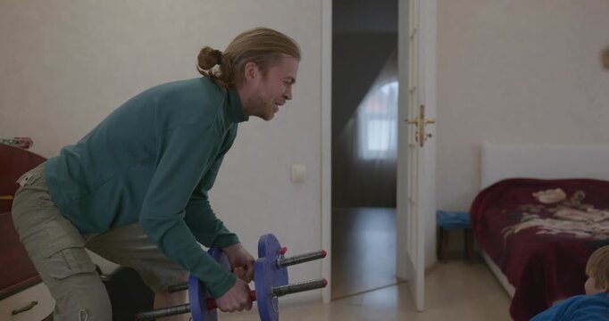 Man Does Exercise Workout with Kid at Home. 4K 10-bit
