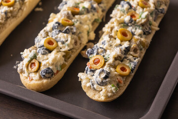 Bread Topped with Cheese Mixture and Olives – Ready to Bake
