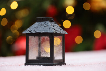 Christmas lantern and festive illumination. New Year decorations on city street, snow winter