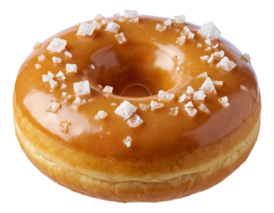 Coarse sea salt crystals resting on the caramel glaze of a doughnut.