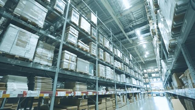 Long Aisle in Large Warehouse with High Shelves and Packed Cardboard Boxes