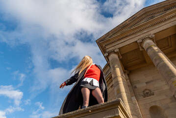 Elegant woman enjoying the wind on a sunny winter day, low angle view