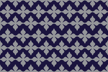 Fototapeta premium A blue Ikat seamless pattern inspired by traditional woven and tie-dye techniques. Featuring soft, blurred geometric motifs characteristic of authentic Ikat craftsmanship, this design offers a calm, 