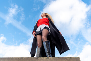 Low angle view with a beautiful woman enjoying a sunny winter day