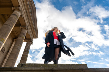 Low angle view with a woman standing in front of a medieval building