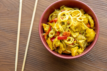 Close-Up of Curry Chicken Noodles in a Red Bowl

